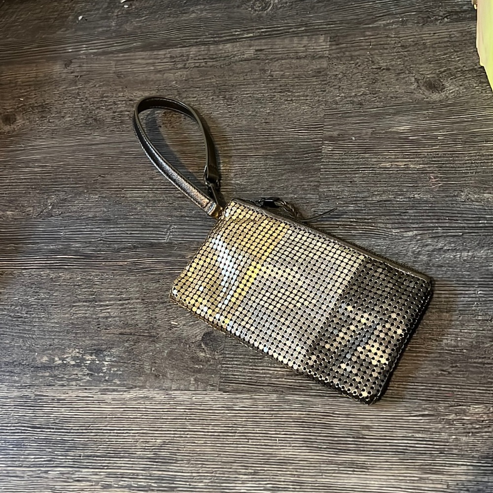this is a little purse that is gold,sliver, and a dark grey